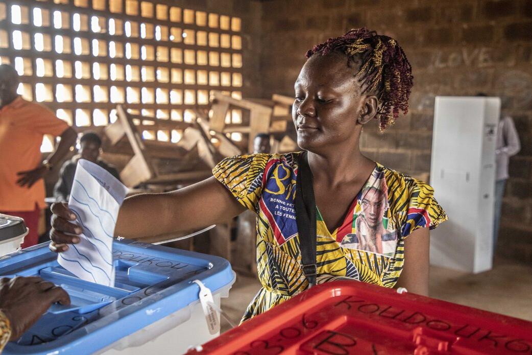 Un électeur dépose un bulletin dans une urne.